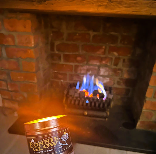 Lit Lang May Yer Lum Reek candle with crackling fireplace scent